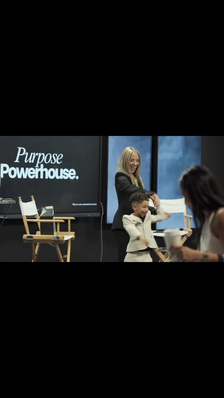Attendees celebrating in front of the Purpose Powerhouse screen at the first live event